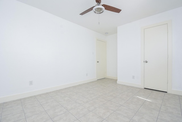 tiled empty room with ceiling fan