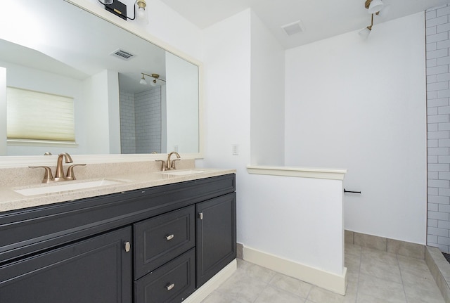 bathroom with tile patterned floors and vanity