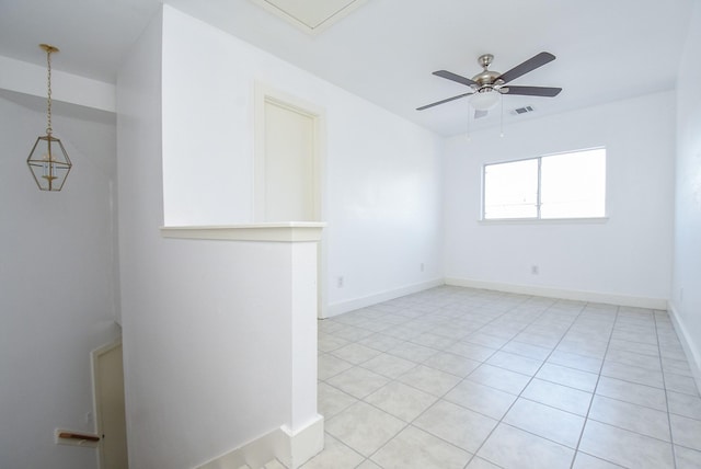 spare room featuring light tile patterned floors and ceiling fan