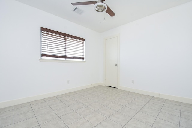 tiled empty room with ceiling fan