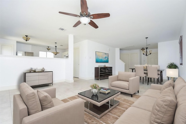 living room with light tile patterned floors and ceiling fan with notable chandelier