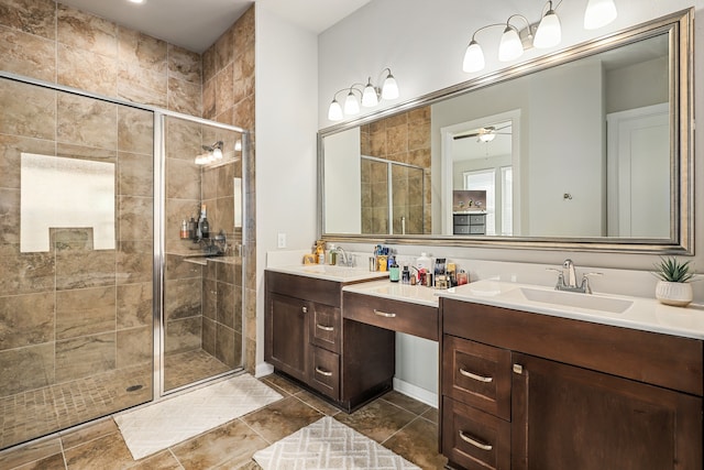 bathroom featuring ceiling fan, a shower with door, and vanity