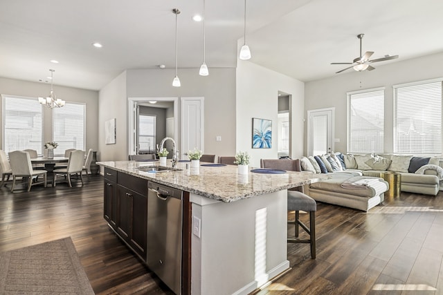 kitchen with stainless steel dishwasher, decorative light fixtures, dark wood-type flooring, and ceiling fan with notable chandelier