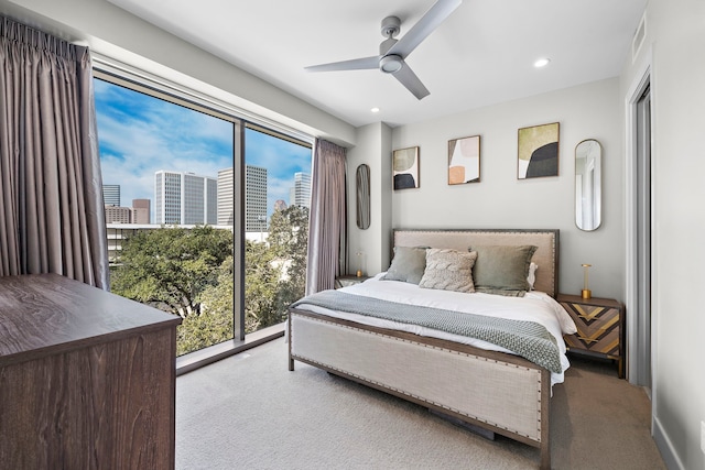 bedroom with ceiling fan and light carpet