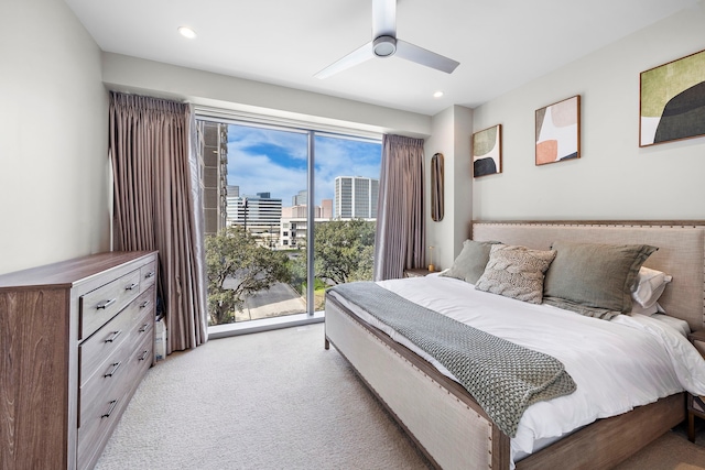 carpeted bedroom featuring multiple windows, access to outside, and ceiling fan