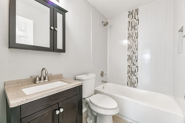 full bathroom featuring tiled shower / bath combo, toilet, and vanity