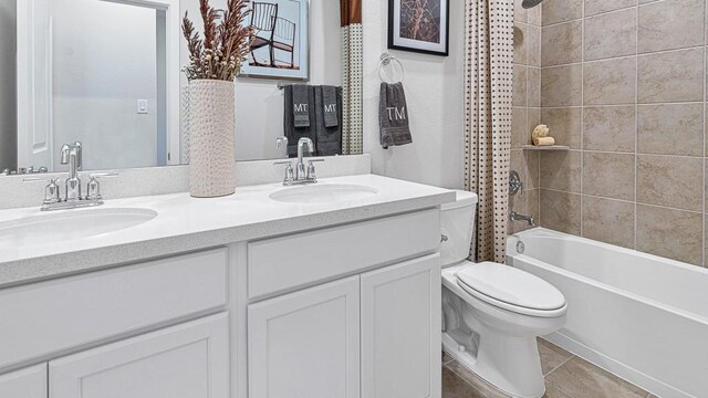 full bathroom featuring tile patterned flooring, vanity, shower / tub combo, and toilet