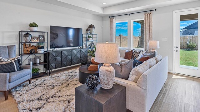 living room featuring a wealth of natural light and light hardwood / wood-style floors