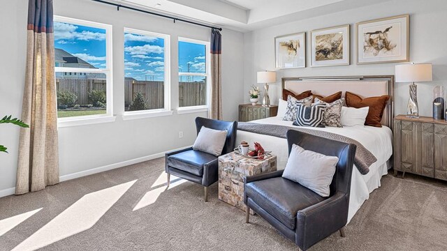 bedroom with light colored carpet and multiple windows