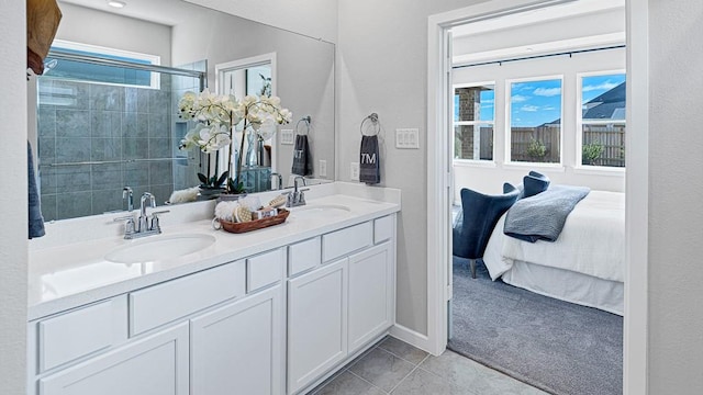 bathroom with tile patterned floors, vanity, a shower with door, and a wealth of natural light