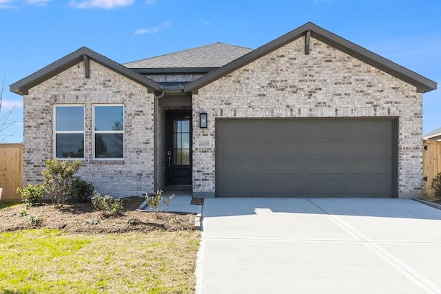 view of front of property featuring brick siding, concrete driveway, an attached garage, and a shingled roof