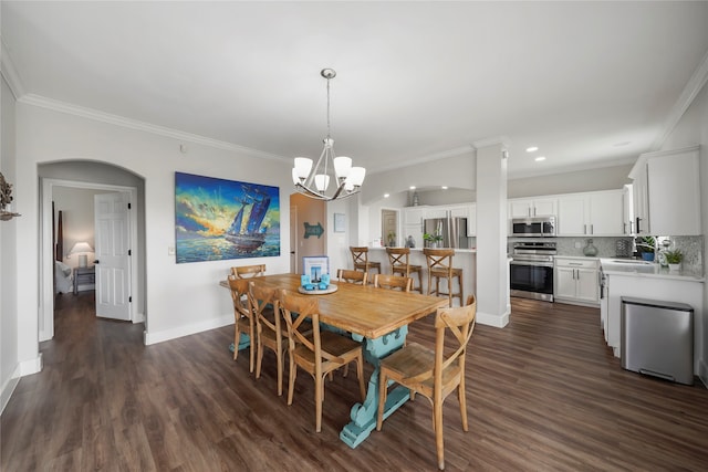 dining space with a chandelier, dark hardwood / wood-style floors, and crown molding