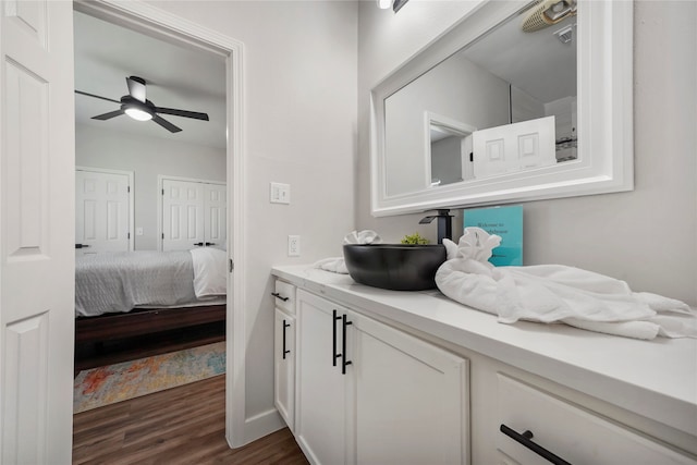 bathroom featuring ceiling fan, wood-type flooring, and vanity