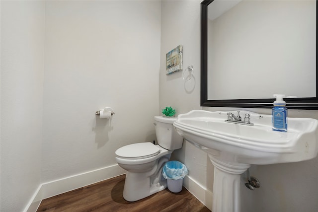 bathroom featuring hardwood / wood-style floors and toilet