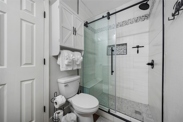 bathroom featuring toilet and walk in shower