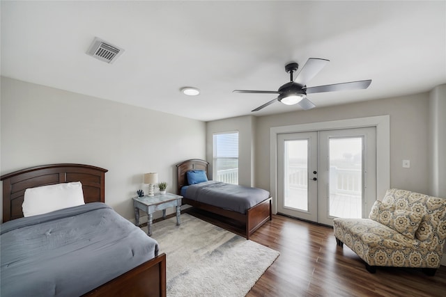 bedroom featuring dark hardwood / wood-style floors, access to exterior, french doors, and multiple windows