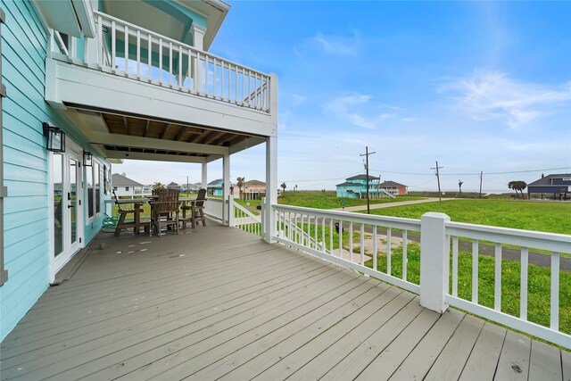 wooden terrace with a yard