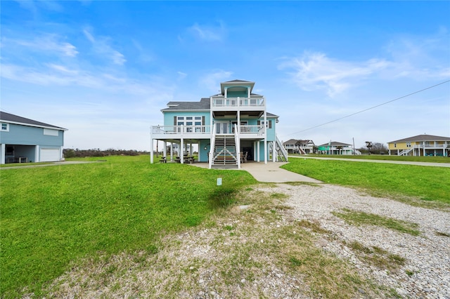 rear view of house featuring a yard and a patio