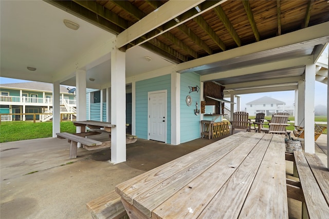 view of patio with a bar and a wooden deck