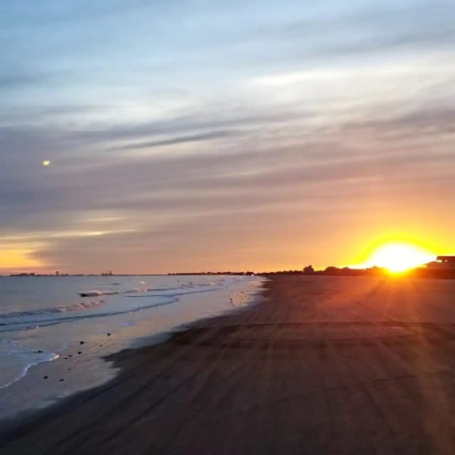 view of street featuring a water view and a view of the beach