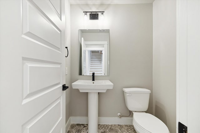 bathroom featuring tile patterned flooring, toilet, and sink