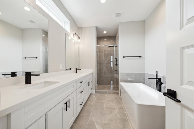 bathroom with shower with separate bathtub and vanity