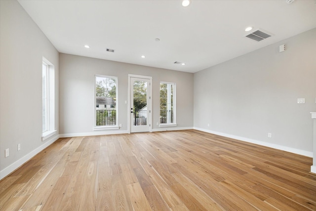 spare room featuring light hardwood / wood-style floors