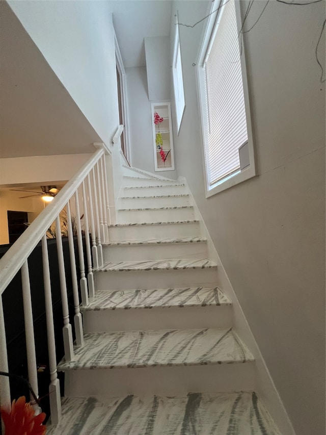 stairway with ceiling fan