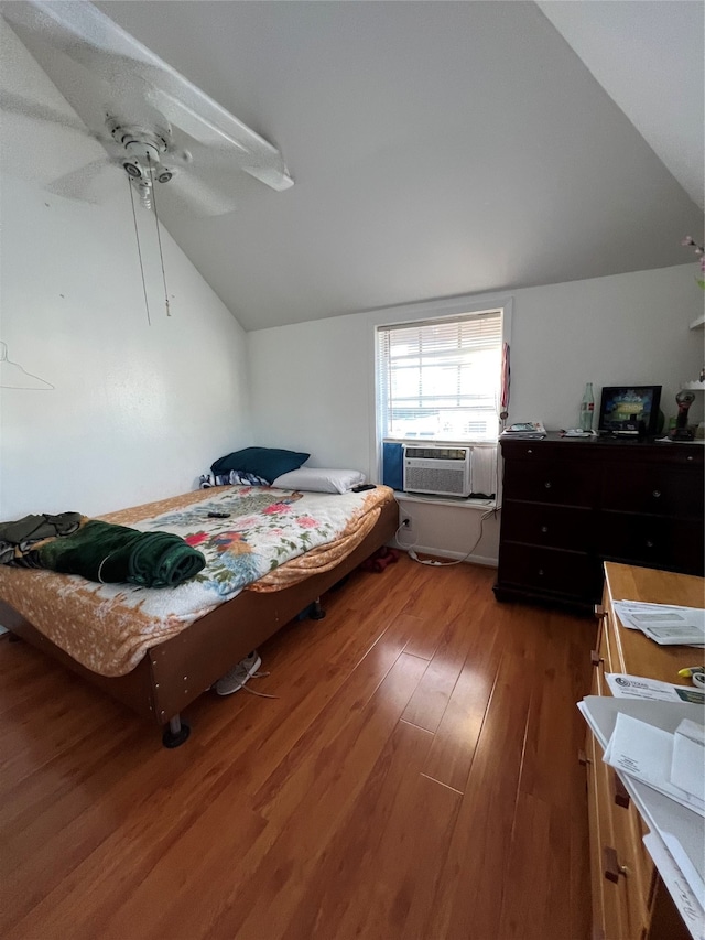 bedroom featuring ceiling fan, cooling unit, wood-type flooring, and vaulted ceiling