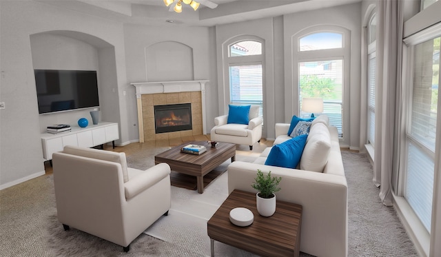 carpeted living room with a fireplace and ceiling fan