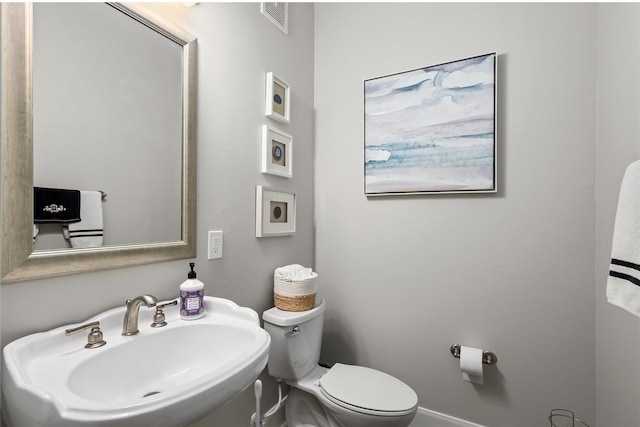 bathroom featuring sink and toilet