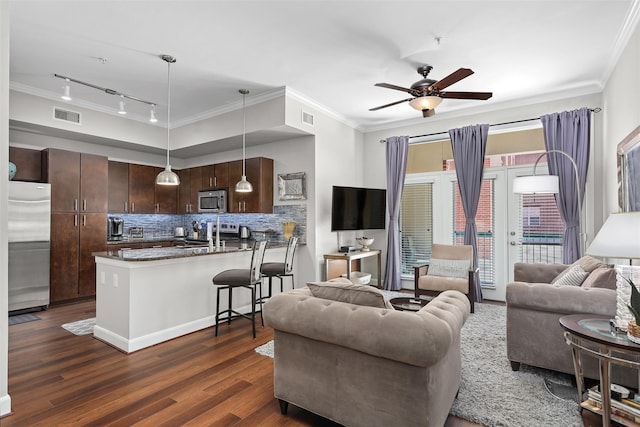300 St Joseph Pkwy Unit 115, Houston, TX 77002 - living room with rail lighting, crown molding, dark wood-type flooring, and ceiling fan