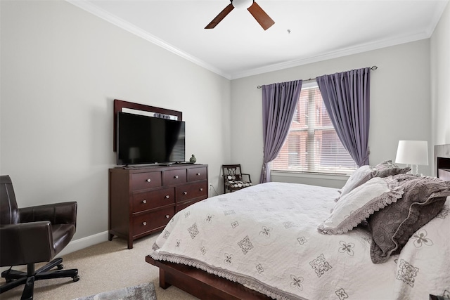 carpeted bedroom featuring ceiling fan and crown molding