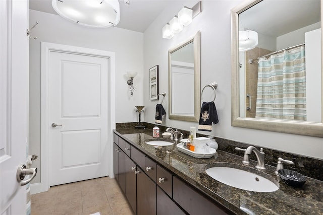 bathroom with tile patterned flooring, vanity, and curtained shower