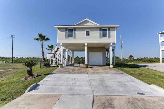 view of front of property with a front lawn, a carport, and a garage