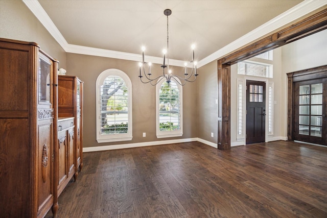 foyer with dark hardwood / wood-style flooring, crown molding, and a notable chandelier