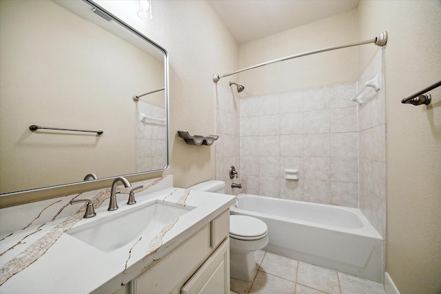 full bathroom with tile patterned flooring, tiled shower / bath combo, toilet, and vanity