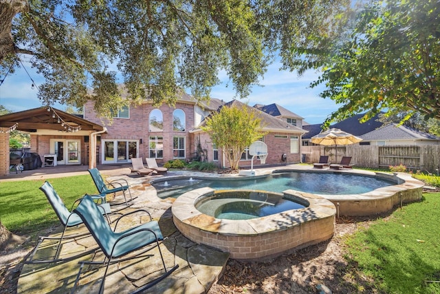 view of pool featuring an in ground hot tub, french doors, grilling area, a patio, and a lawn