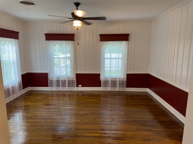 spare room featuring plenty of natural light, dark wood-type flooring, and ceiling fan