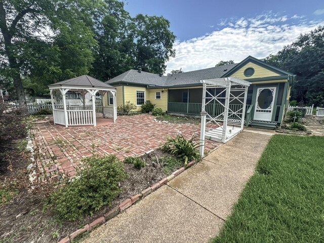 rear view of house with a gazebo