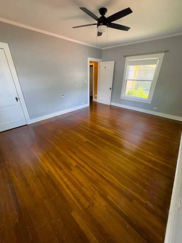 spare room with dark hardwood / wood-style floors, ceiling fan, and crown molding