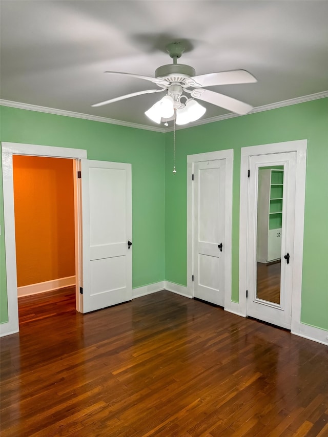 unfurnished bedroom with ceiling fan, dark hardwood / wood-style floors, and ornamental molding