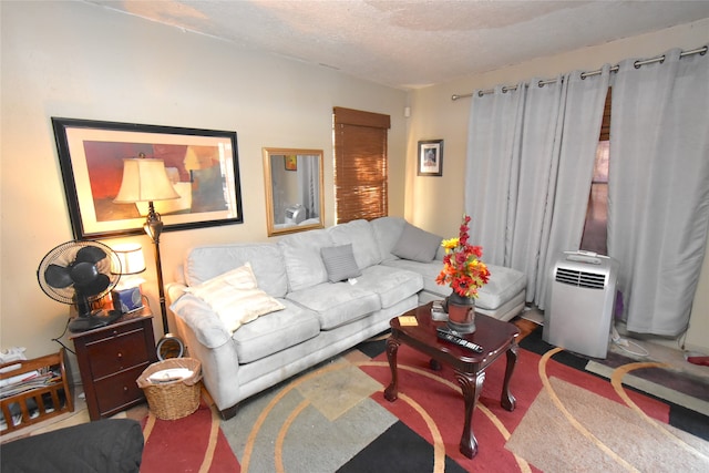 carpeted living room featuring a textured ceiling