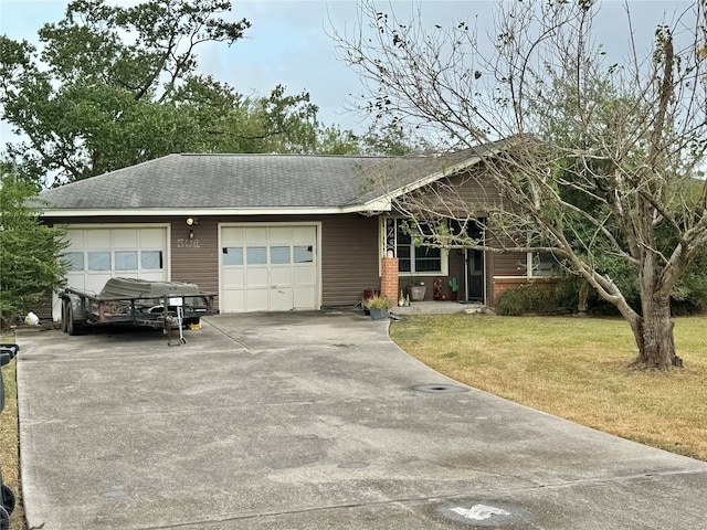 ranch-style house featuring a garage and a front yard