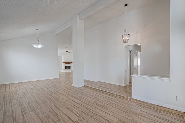 spare room featuring a textured ceiling, ceiling fan with notable chandelier, high vaulted ceiling, and light hardwood / wood-style flooring