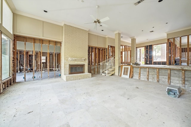 unfurnished living room with ceiling fan, ornamental molding, and a fireplace