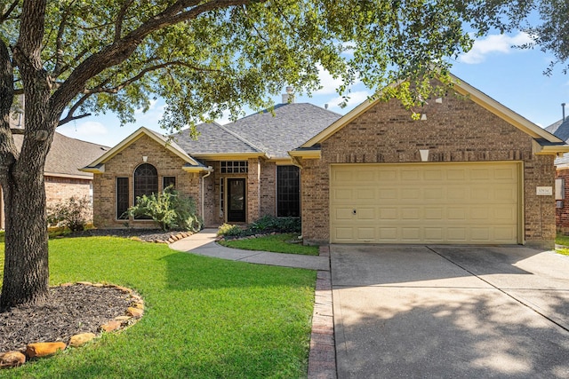 view of front of house featuring a garage and a front lawn