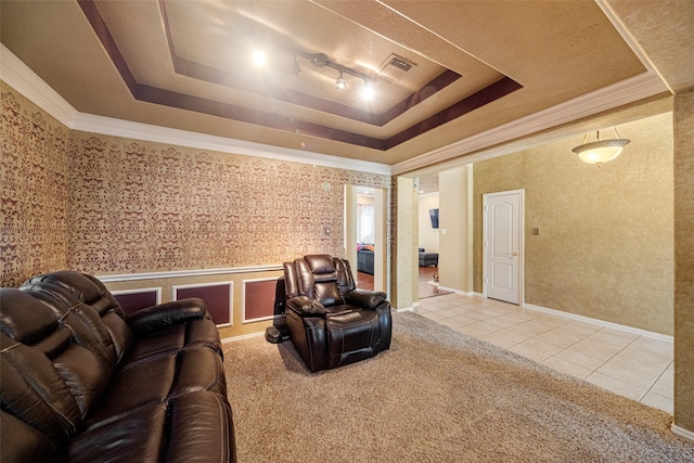 tiled home theater with a raised ceiling and ornamental molding