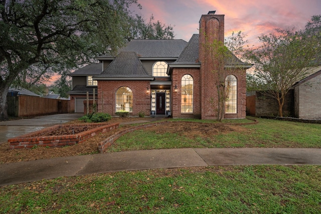 view of front of house with a garage and a yard