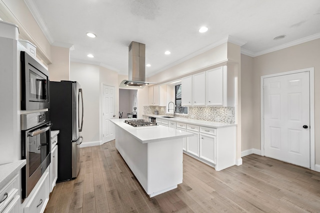 kitchen featuring white cabinetry, appliances with stainless steel finishes, island range hood, a kitchen island, and light wood-type flooring